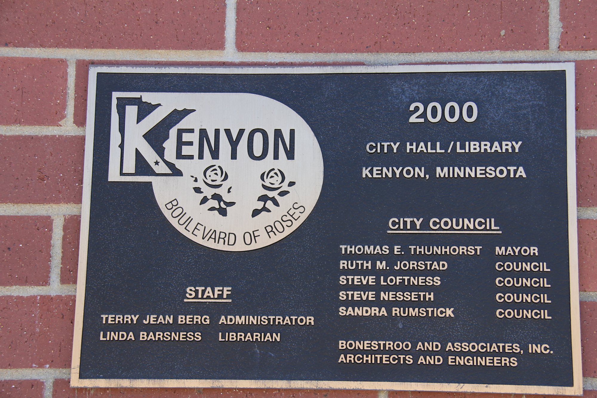 Bronze plaque with the Kenyon Boulevard of Roses emblem, two roses inside a Minnesota outline